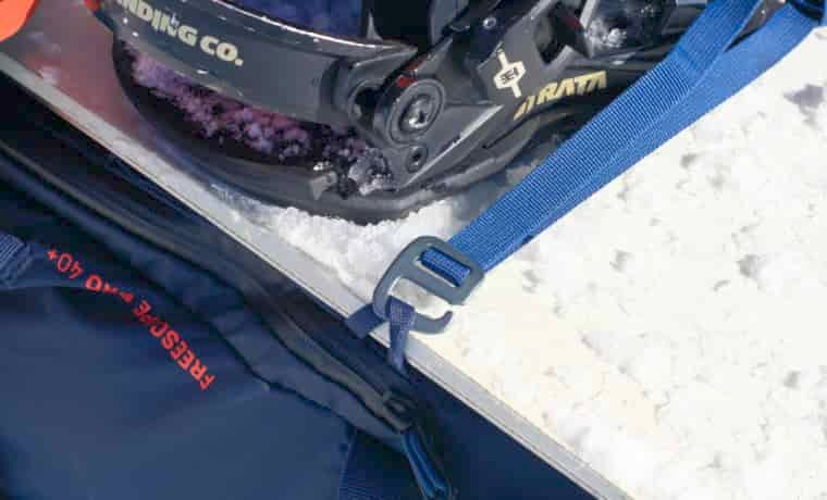 Snowboard attachment on backpack