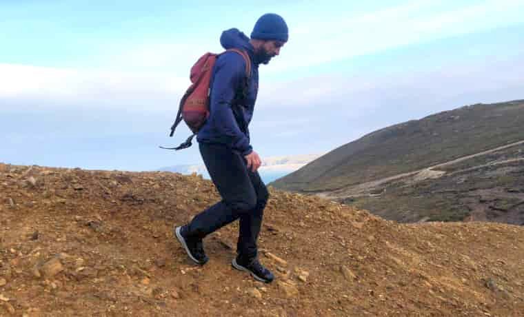 Man walking down slope