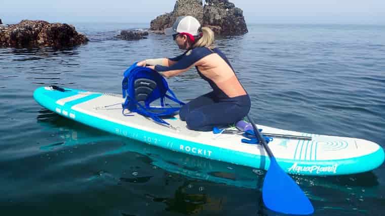 Woman adjusting paddle board kayak seat