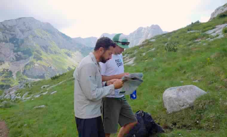 Men map reading in the mountains