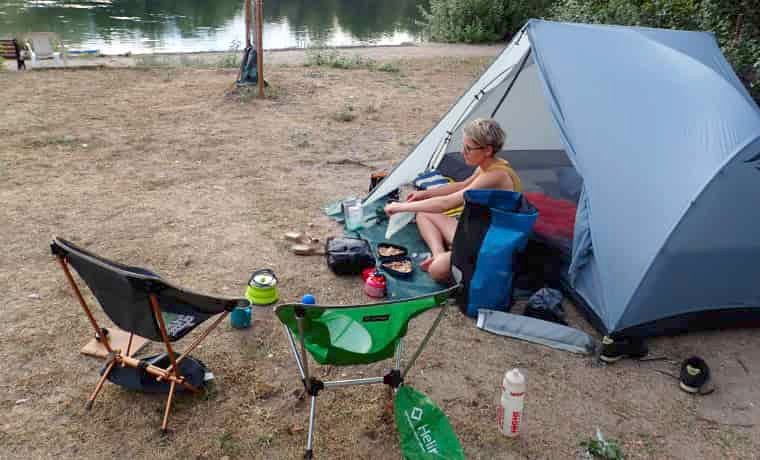 Woman cooking outside tent