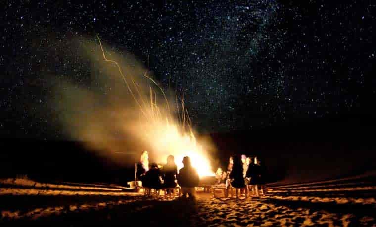 People sat around a Campfire