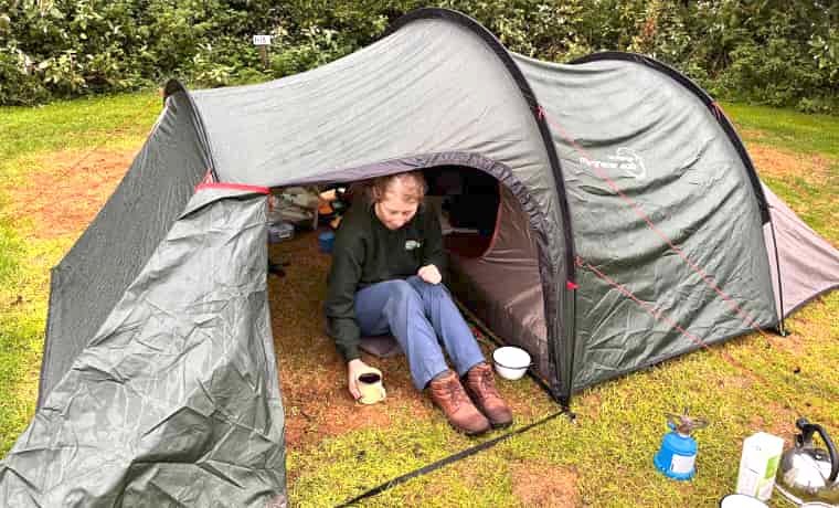 Woman sitting in porch of tent