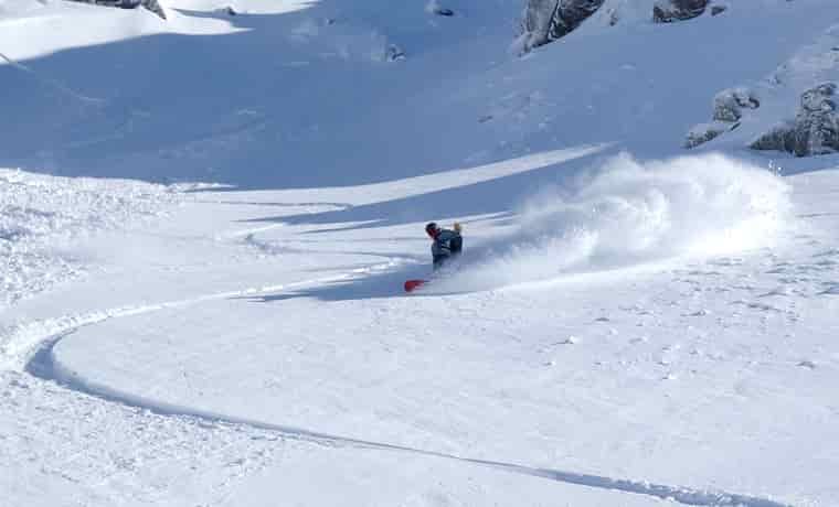 Man snowboarding off piste