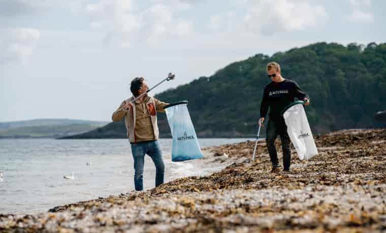 Men picking up beach litter