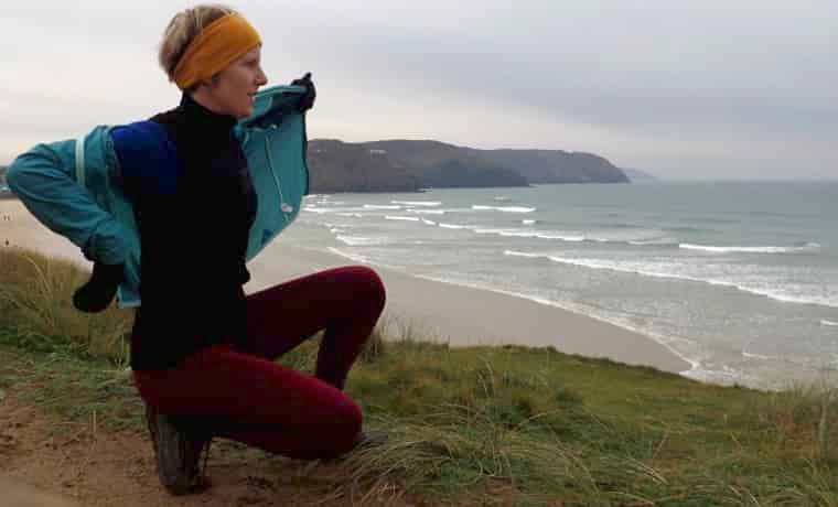 Woman taking off winter running jacket