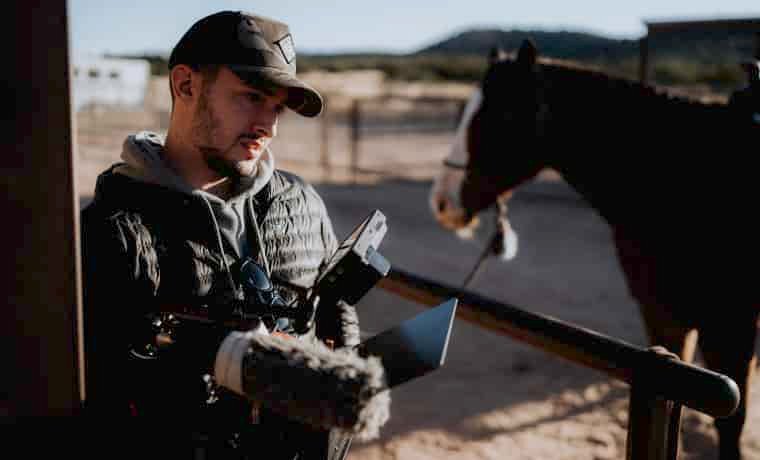 Adventure filmmaker with horse