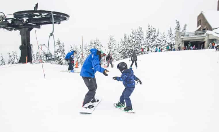 Snowboarding instructor and pupil in the snow
