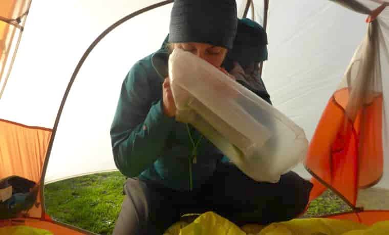 Woman inflating pillow