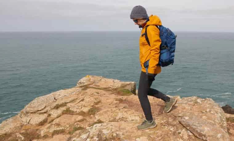 Woman hiking by the coast