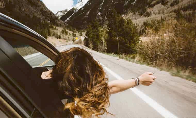 Woman leaning out of car