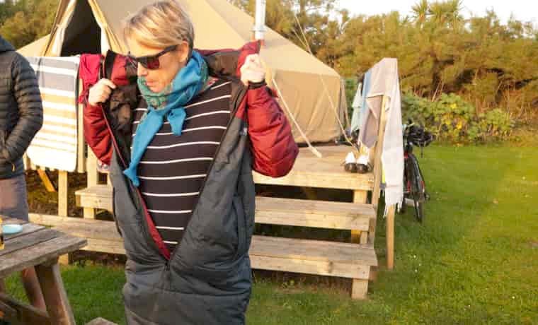 Woman putting jacket on