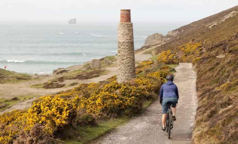 Woman cycling by the sea