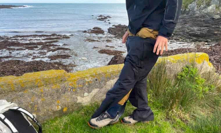 man putting on waterproof pants