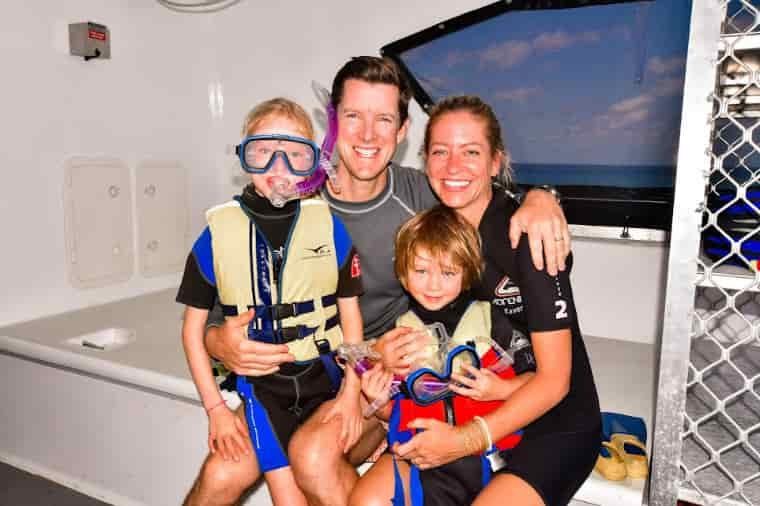 Family on boat with snorkelling gear