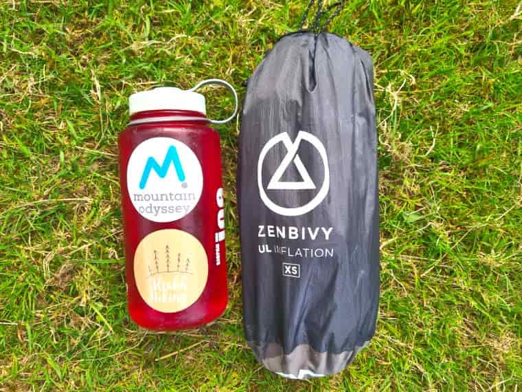 Camping mattress packed next to bottle