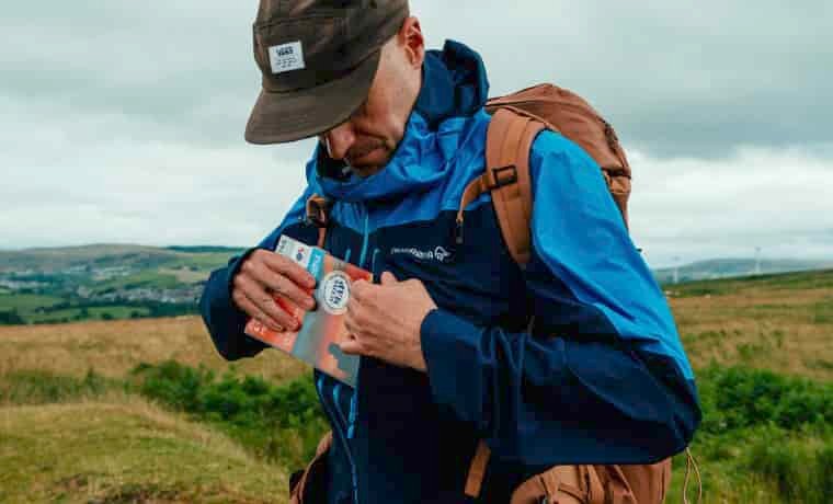 Hiker putting map in jacket pocket