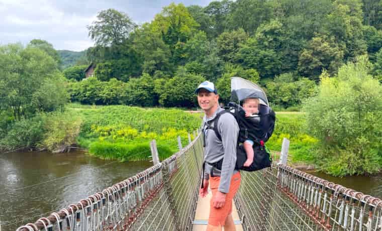 Man carrying child on bridge