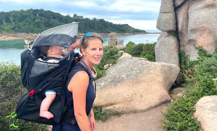 Woman carrying baby in Osprey Poco Lt baby carrier