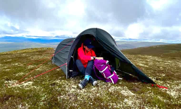 Woman sitting in porch of tent