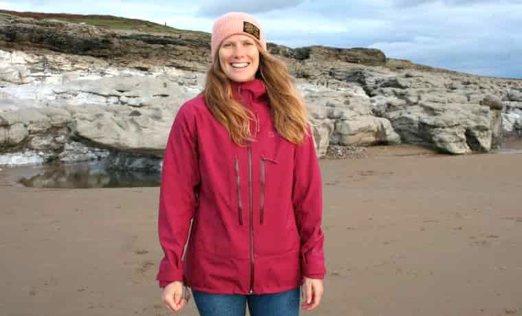 Woman on beach in red jacket