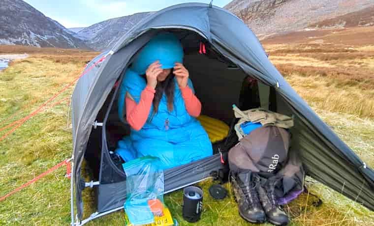 Woman camping in the mountains