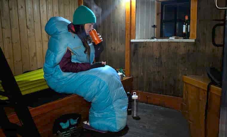 Woman in thermarest sleeping bag in bothy