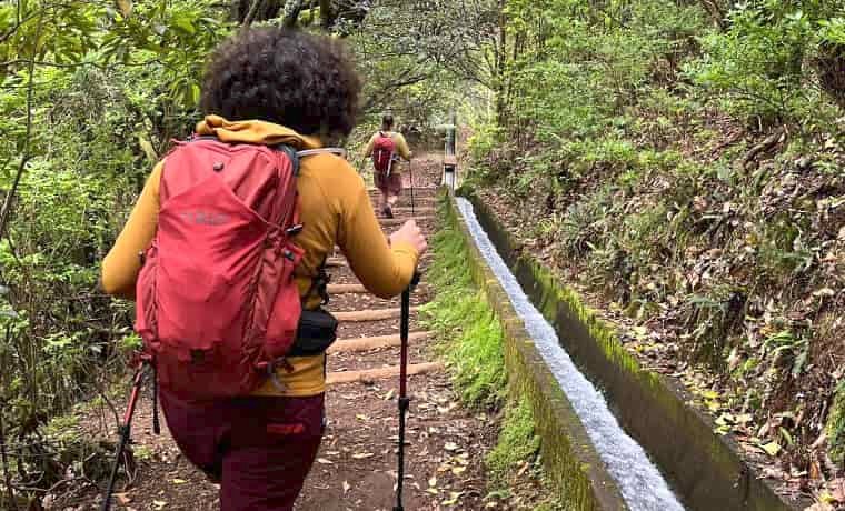 Woman hiking with red backpack in the forest
