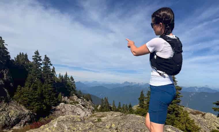 Woman in mountains in running vest