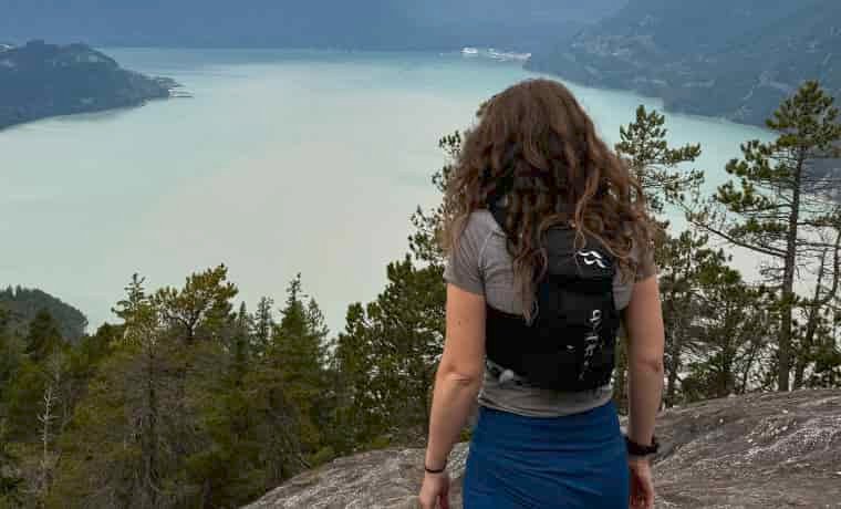 Woman in running vest by lake