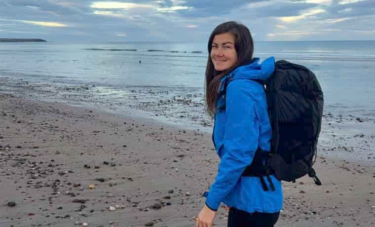 Woman on the beach with backpack